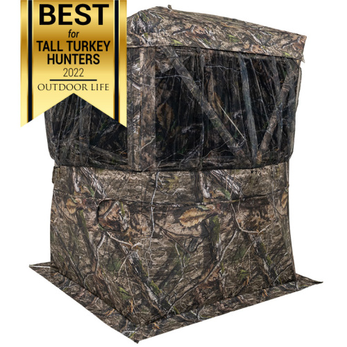 Envy Blind - Mossy Oak® Country DNA® - Front quarter view of blind showing ground skirt and 180° curtain-style viewing area with 